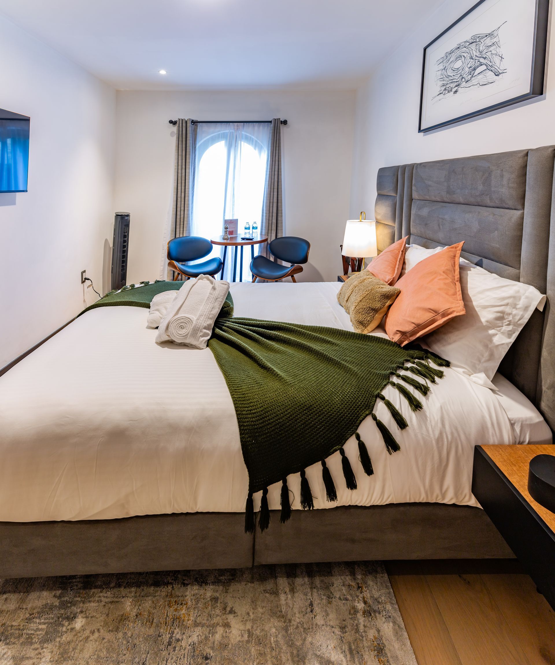 Una habitación de hotel con una cama tamaño king y una mesa y sillas.