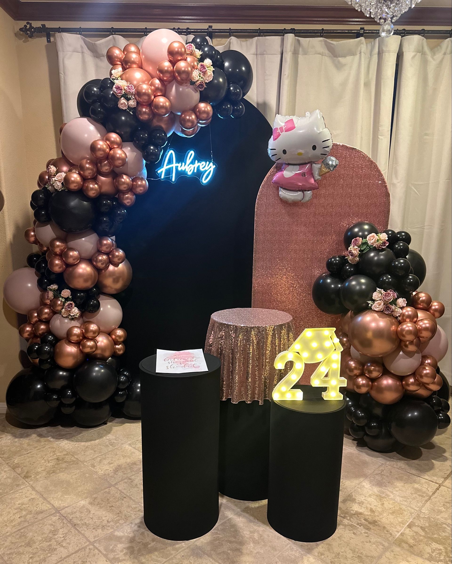 A room filled with balloons and a hello kitty balloon.