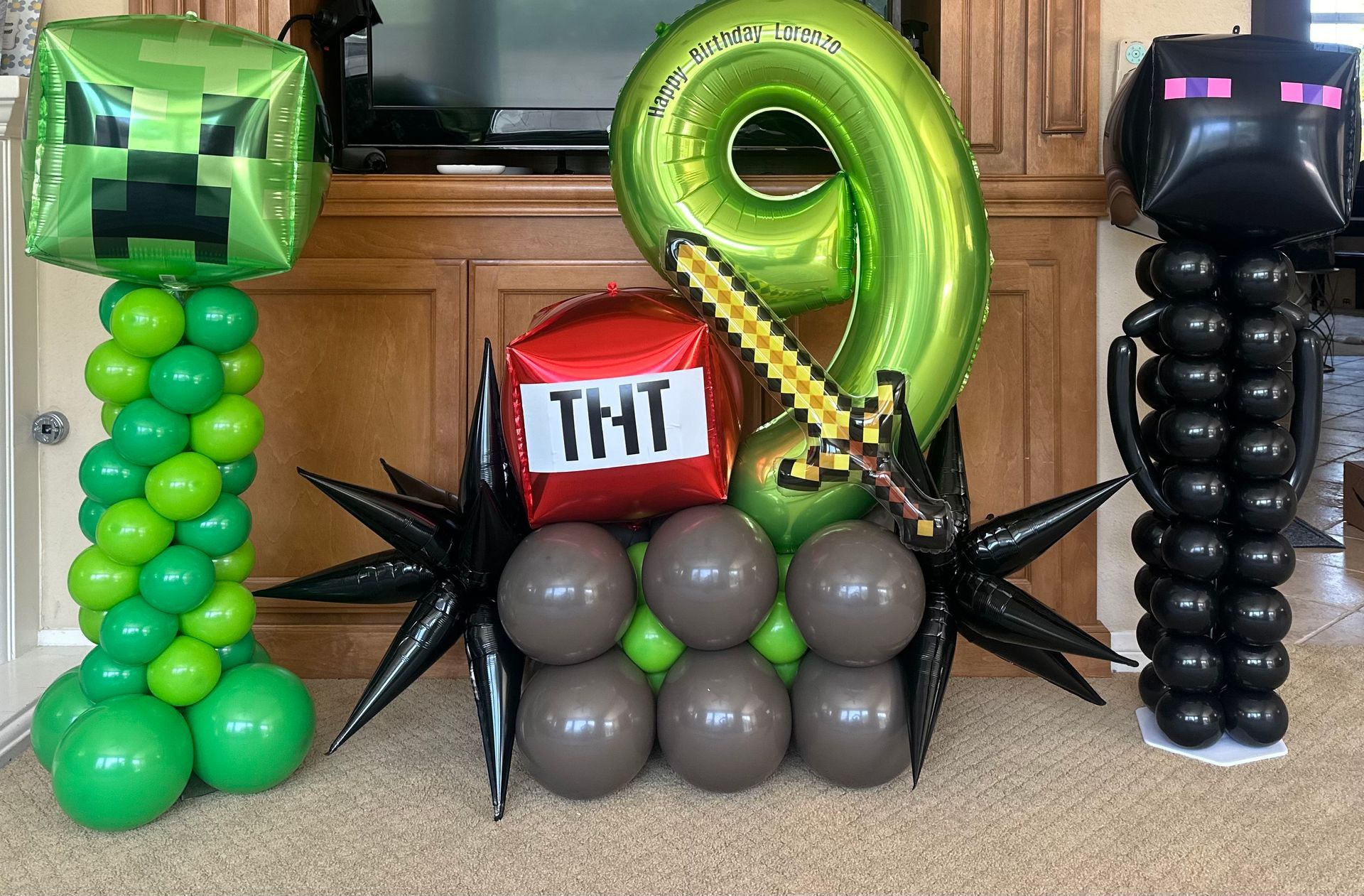 A bunch of balloons with one that says tnt on it