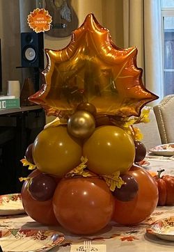 A bunch of balloons are sitting on top of each other on a table.