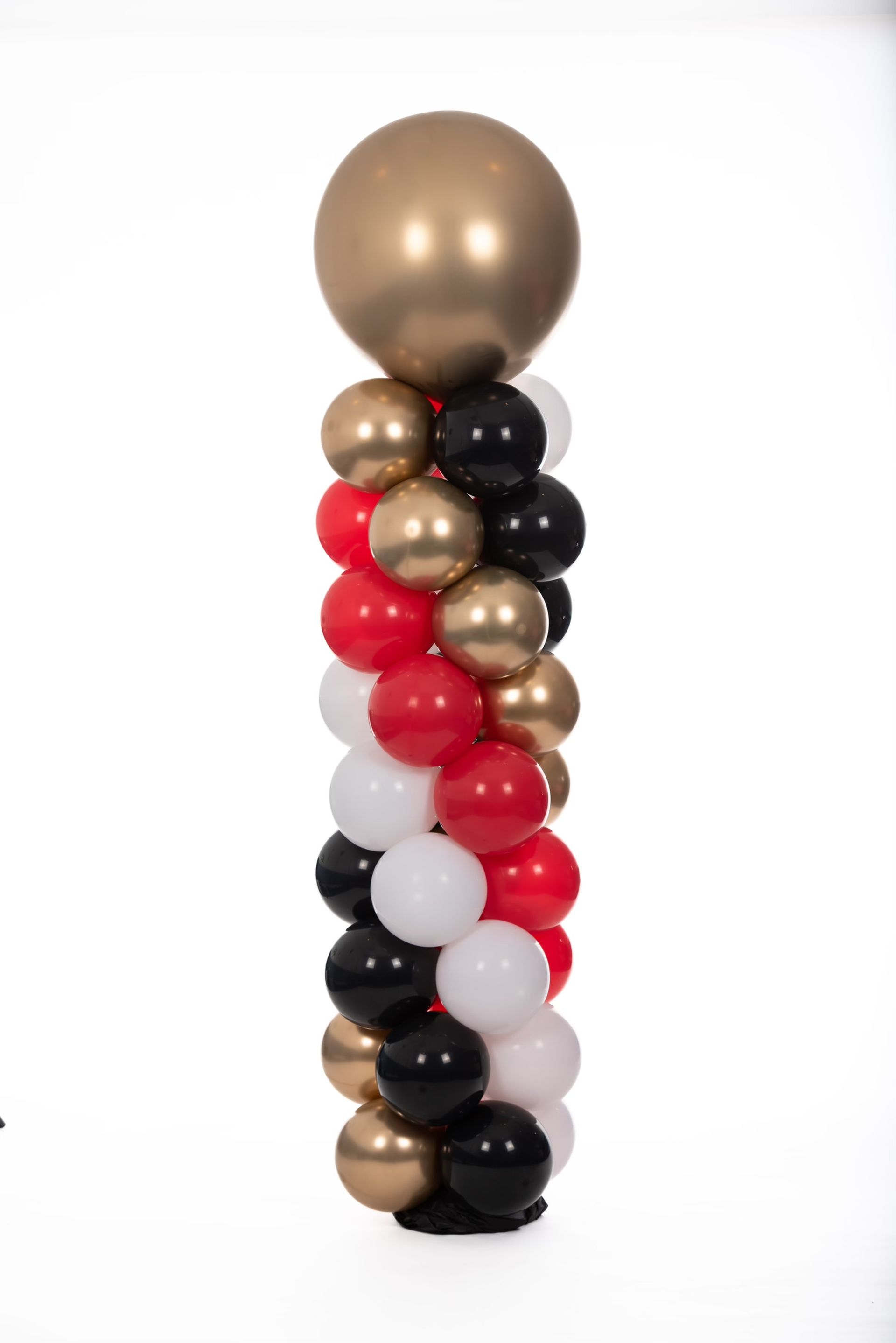 A column of red , black , and gold balloons on a white background.