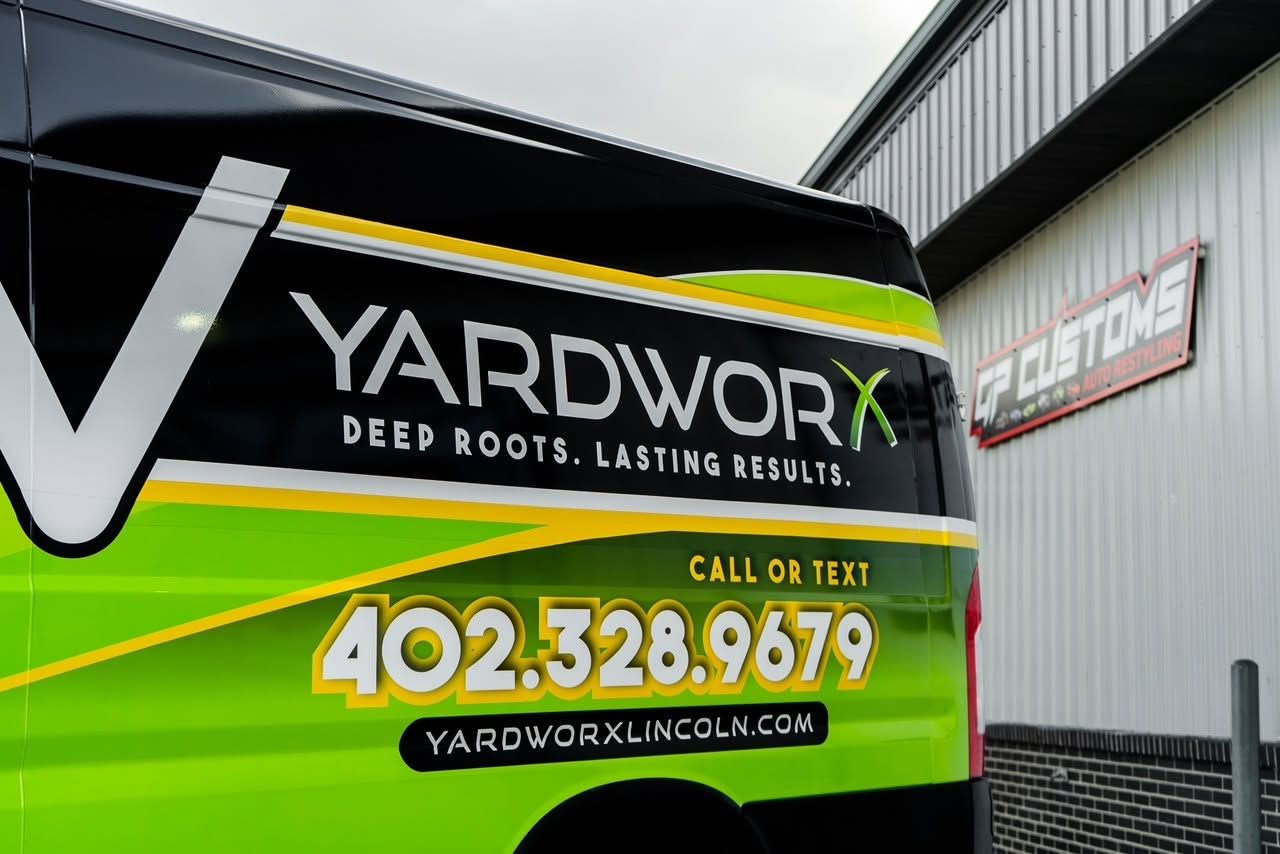 Yardworx lawn care truck wrap with green and black branding, website, and phone number 402-328-9679