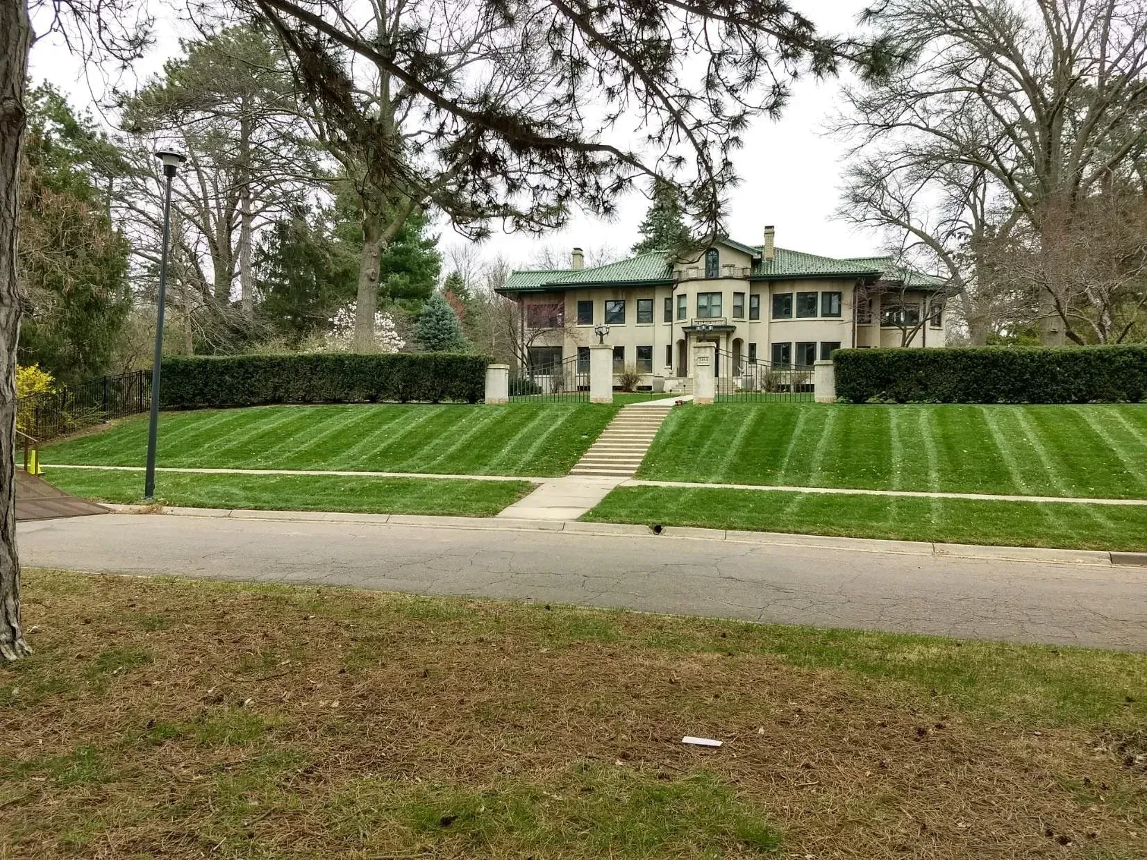 A large house with a lush green lawn in front of it.