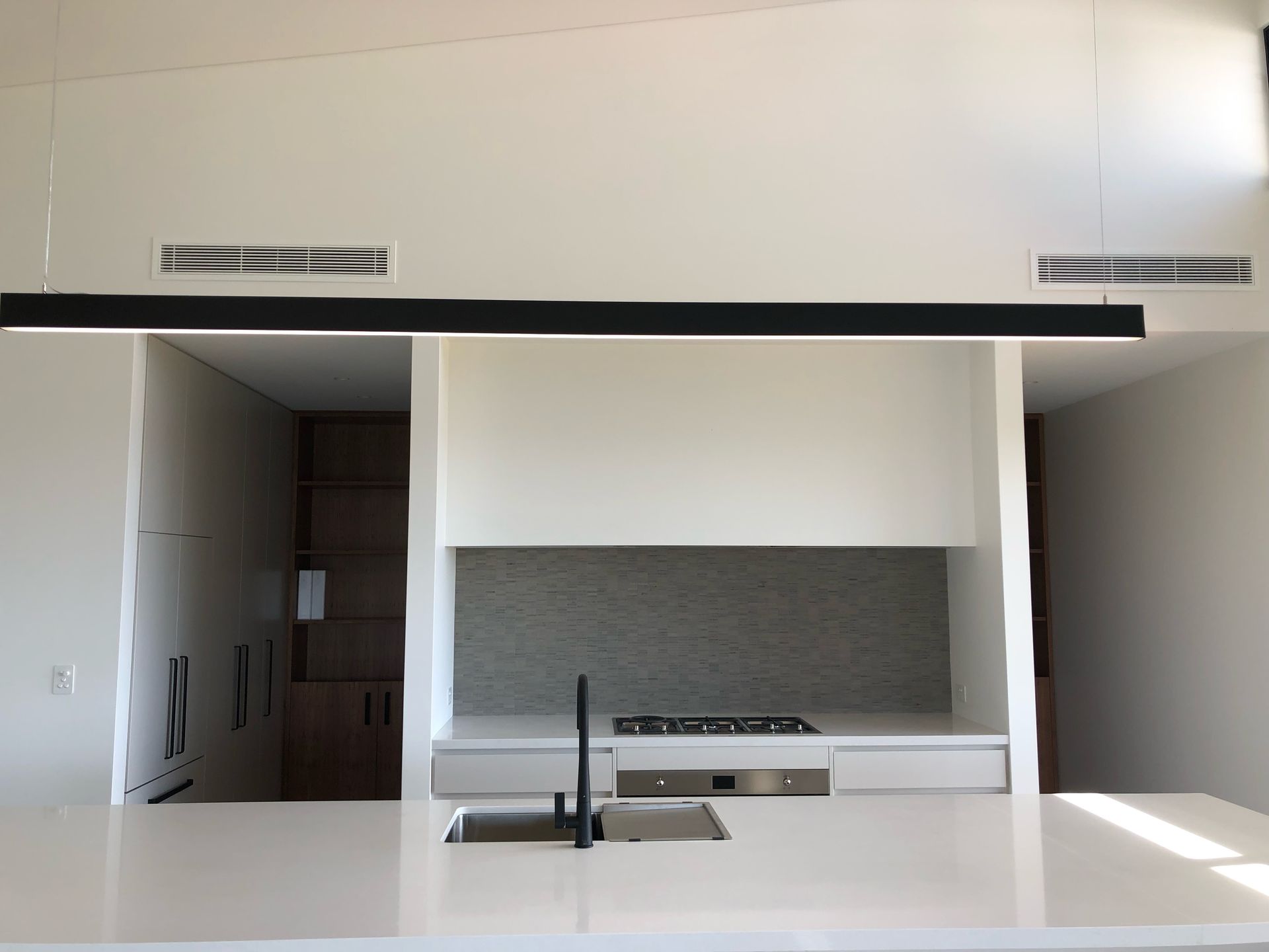 a kitchen with an air con unit — AJM's Air Conditioning Centre in Lismore, NSW
