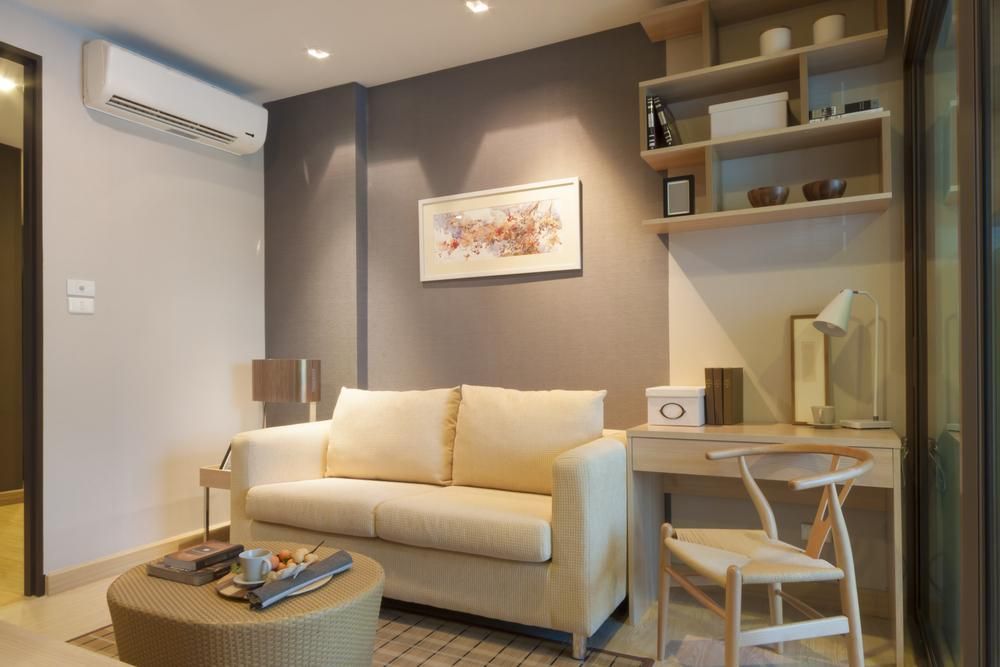 A Living Room With a Couch and a Desk — AJM's Air Conditioning Centre in Wollongbar, NSW