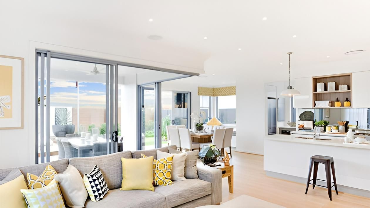 A Living Room With a Couch and a Kitchen in the Background — AJM's Air Conditioning Centre in Lismore, NSW