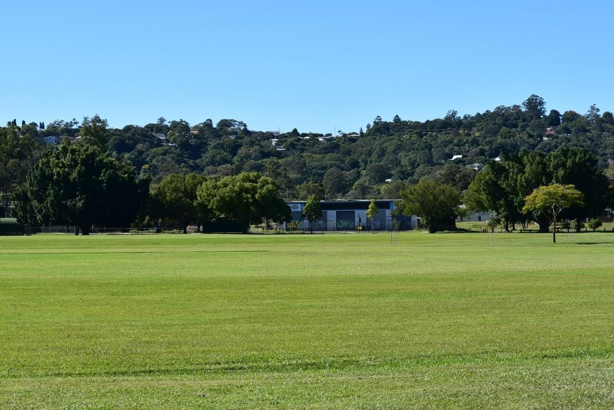 A Large Grassy Field With Trees in the Background — AJM's Air Conditioning Centre in Lismore, NSW
