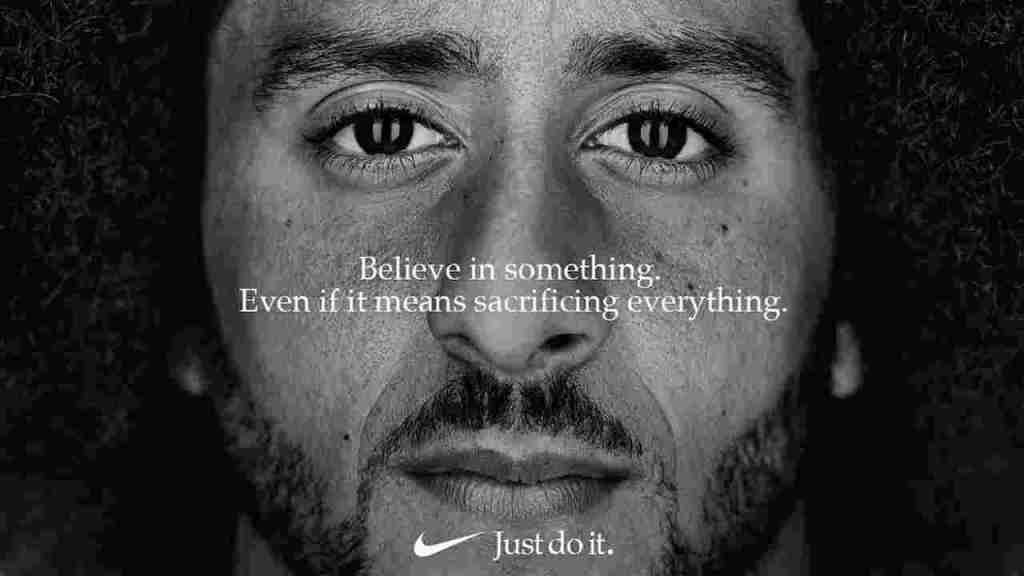 Black-and-white close-up of a man’s face with Nike slogan, “Believe in something. Even if it means sacrificing everything.”