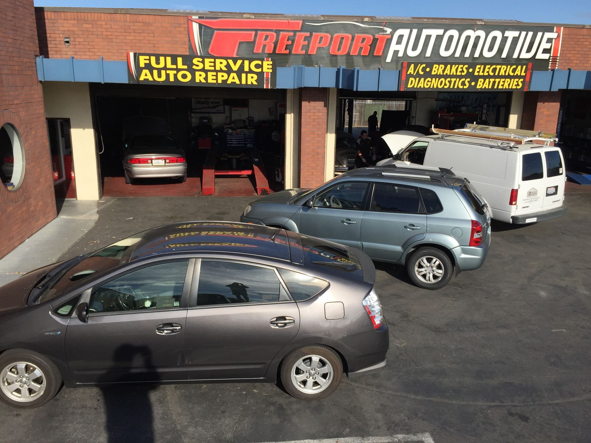 Cars are parked in front of a freeport automotive store