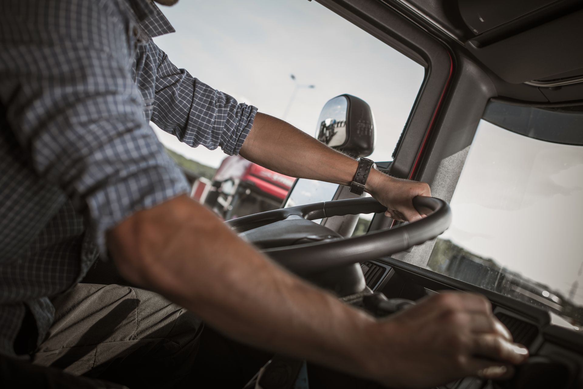 A man is driving a semi truck on a highway.