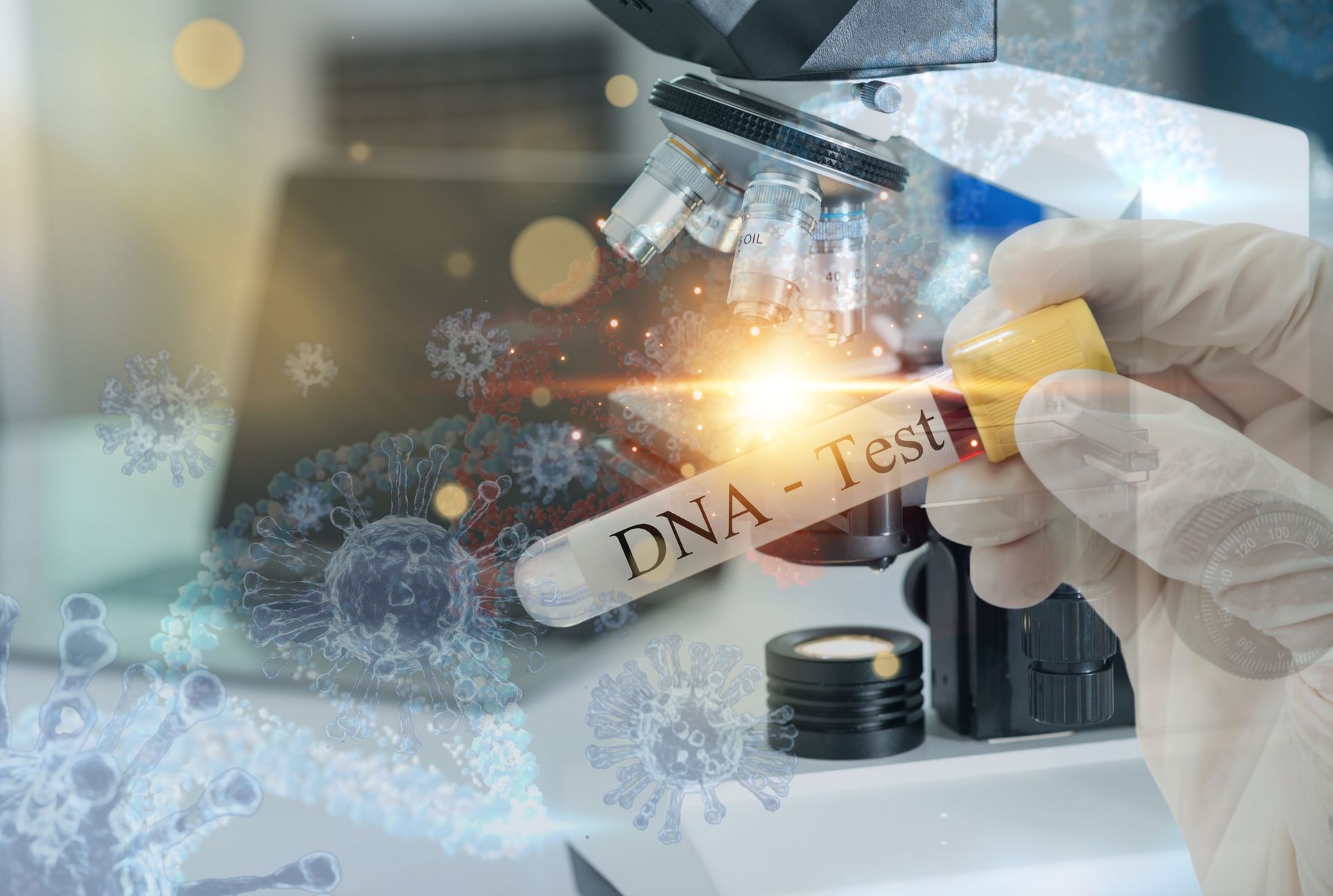 A person is holding a test tube in front of a microscope.