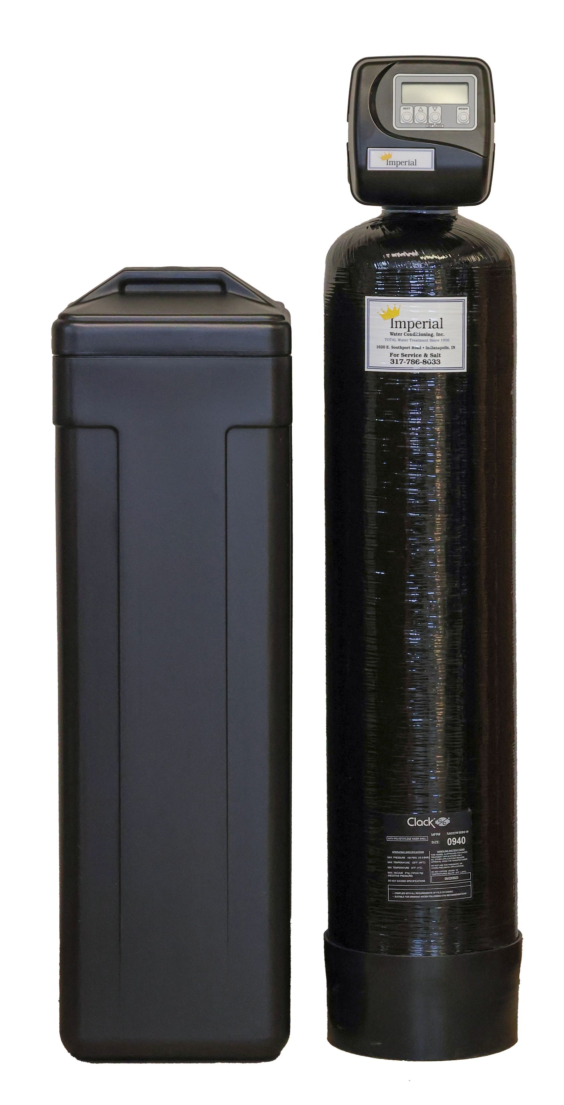 A black water softener is sitting next to a black box on a white background.