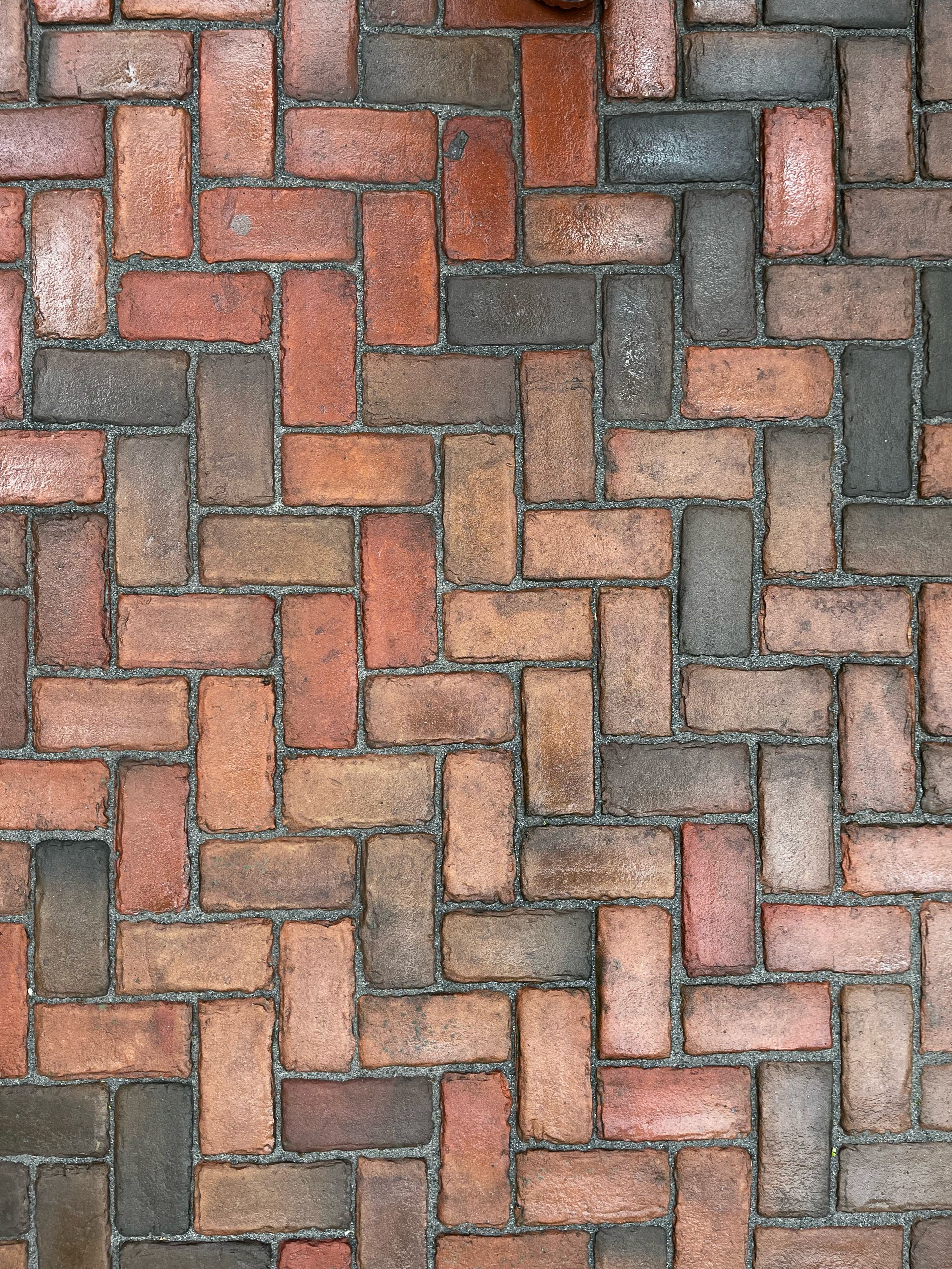 Un gros plan d'une allée en briques avec un motif à chevrons