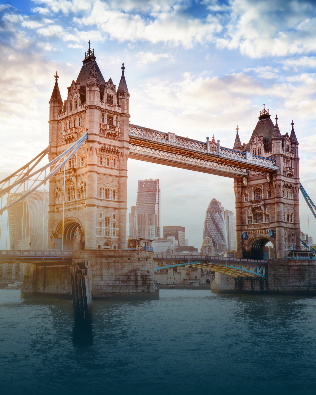 Tower Bridge in London, England, spans the River Thames; the city skyline is in the background.