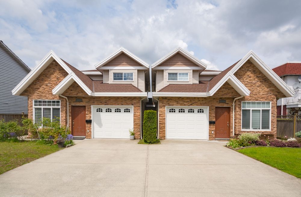 Two Brick Duplex Homes With Driveways, White Garage Doors — All Around Concreting in Ballina, NSW