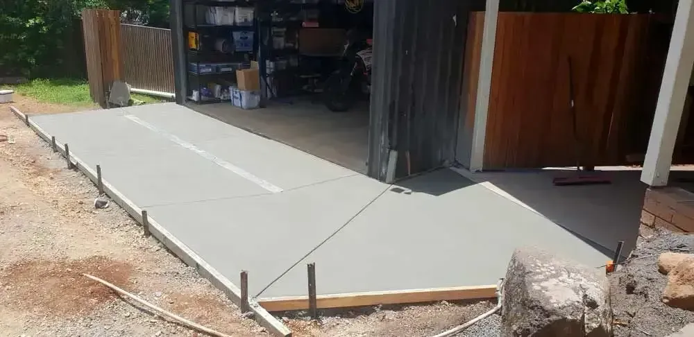 Freshly Poured Concrete Driveway and Walkway Outside a Garage — All Around Concreting in Wollongbar, NSW