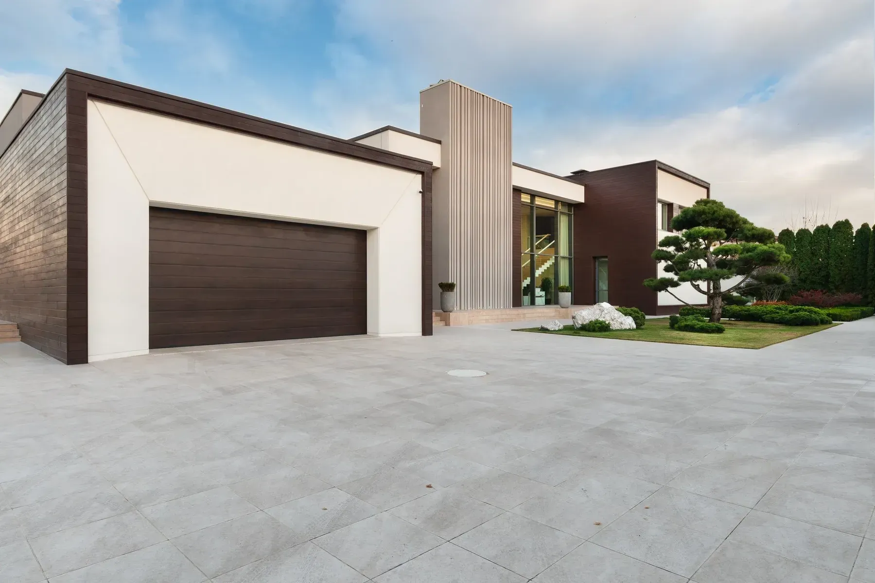 Modern House With Brown Garage Door, Light Stone Driveway — All Around Concreting in Lismore, NSW