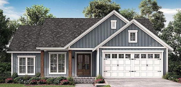 Gray suburban house with white trim, dark roof, and a two-car garage in front of trees