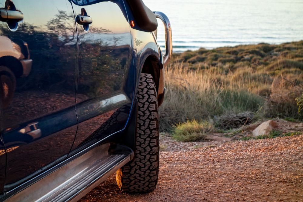 Dark Blue Off Road SUV Parked by A Coastal Trail at Sunset — Bundaberg Field Service in Bundaberg East, QLD
