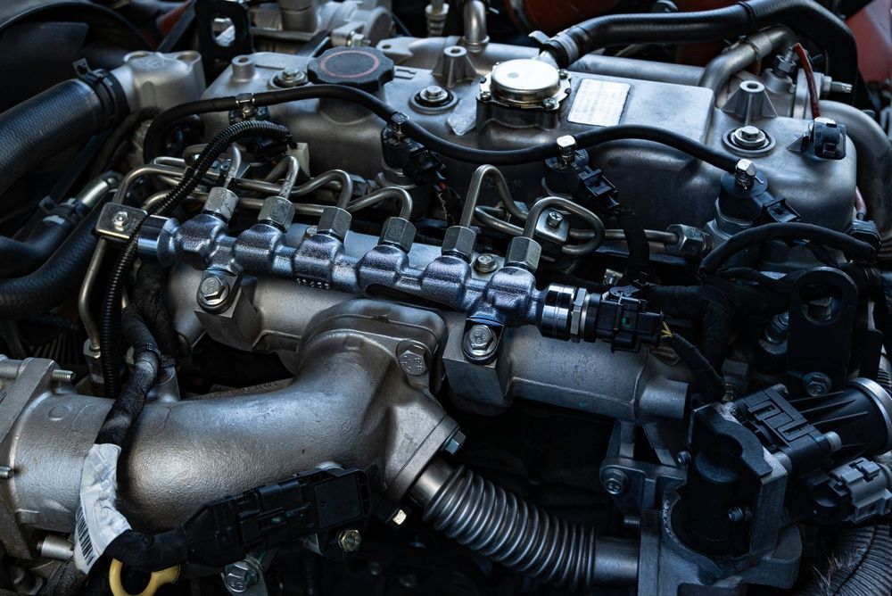 Close-up of a car engine with visible hoses, pipes, and metal components in the engine bay — Bundaberg Field Service in Bargara, QLD