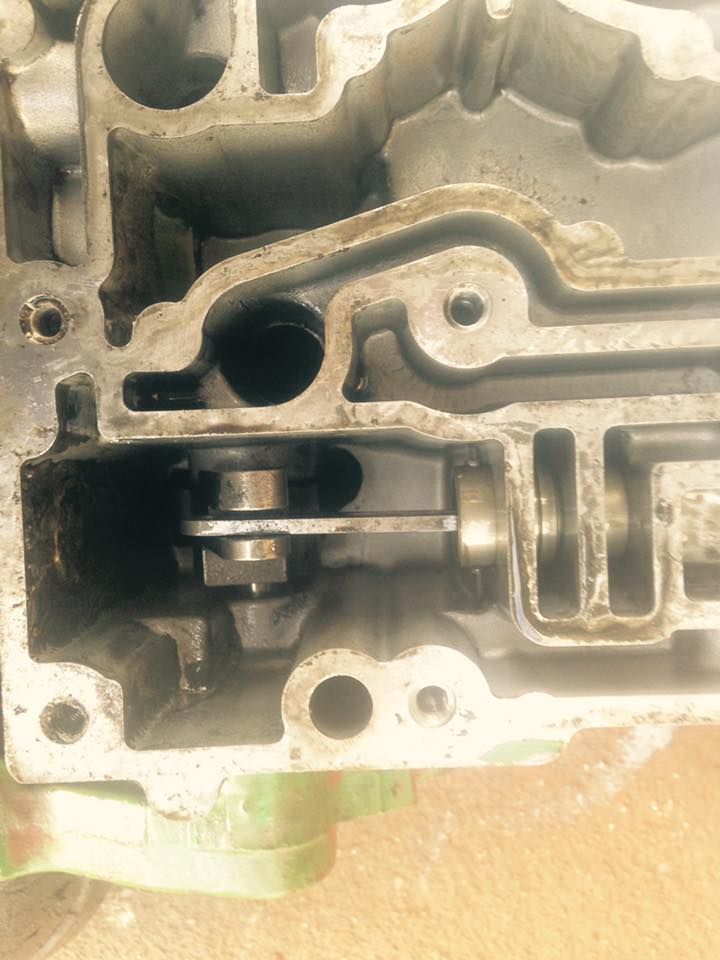 Close-up of a metal engine housing with internal channels, bolts, and a small lever assembly — Bundaberg Field Service in Bundaberg East, QLD