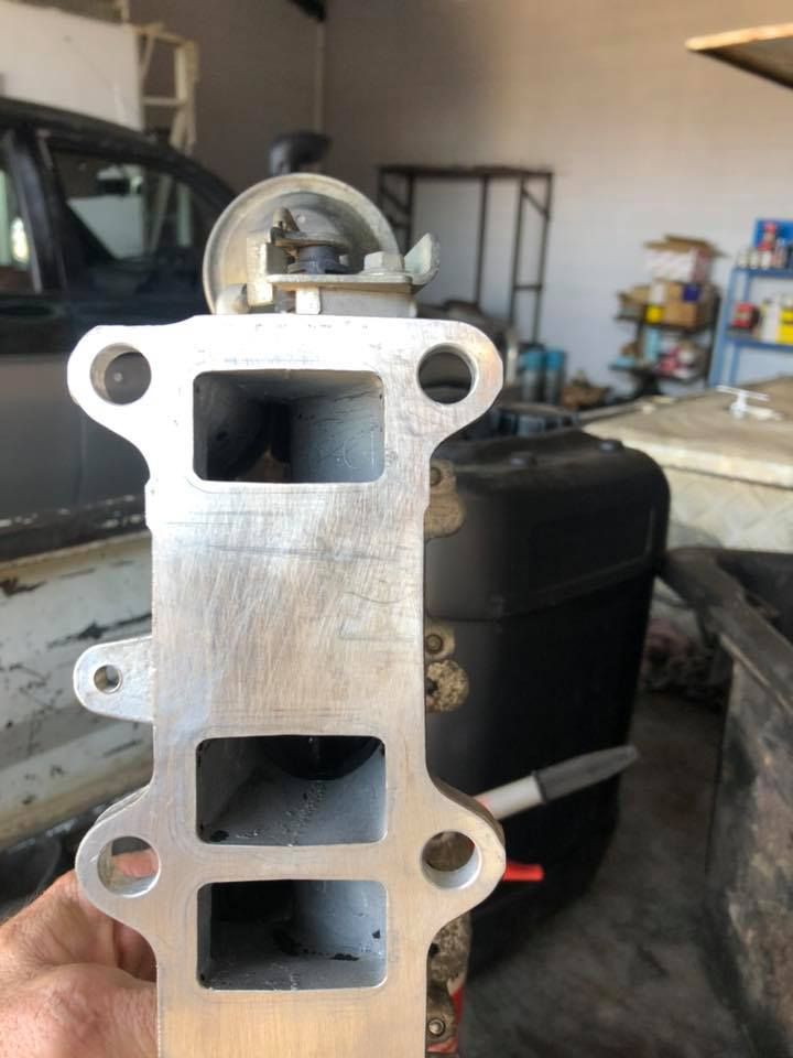 Metal Engine Intake Manifold Held Upright in A Workshop — Bundaberg Field Service in Bundaberg East, QLD