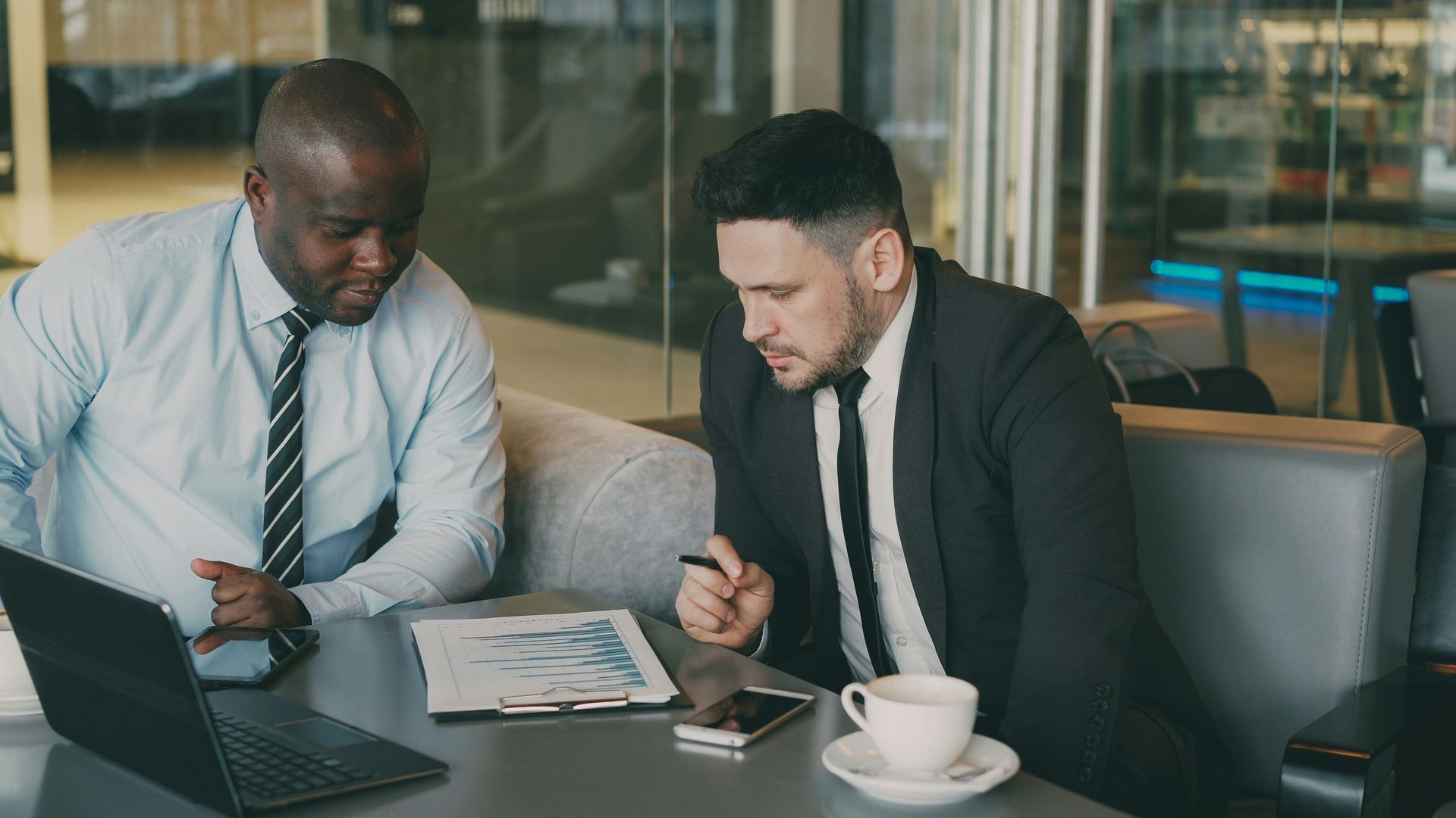 Company directors reviewing pension contribution figures during a business meeting.