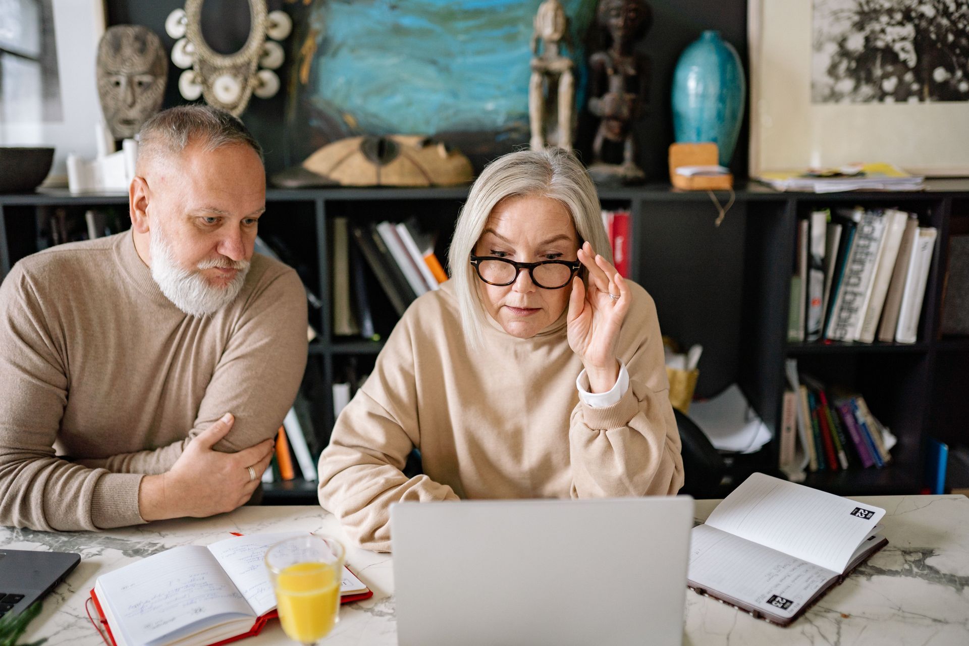 Mature couple reviewing their finances before State Pension age.