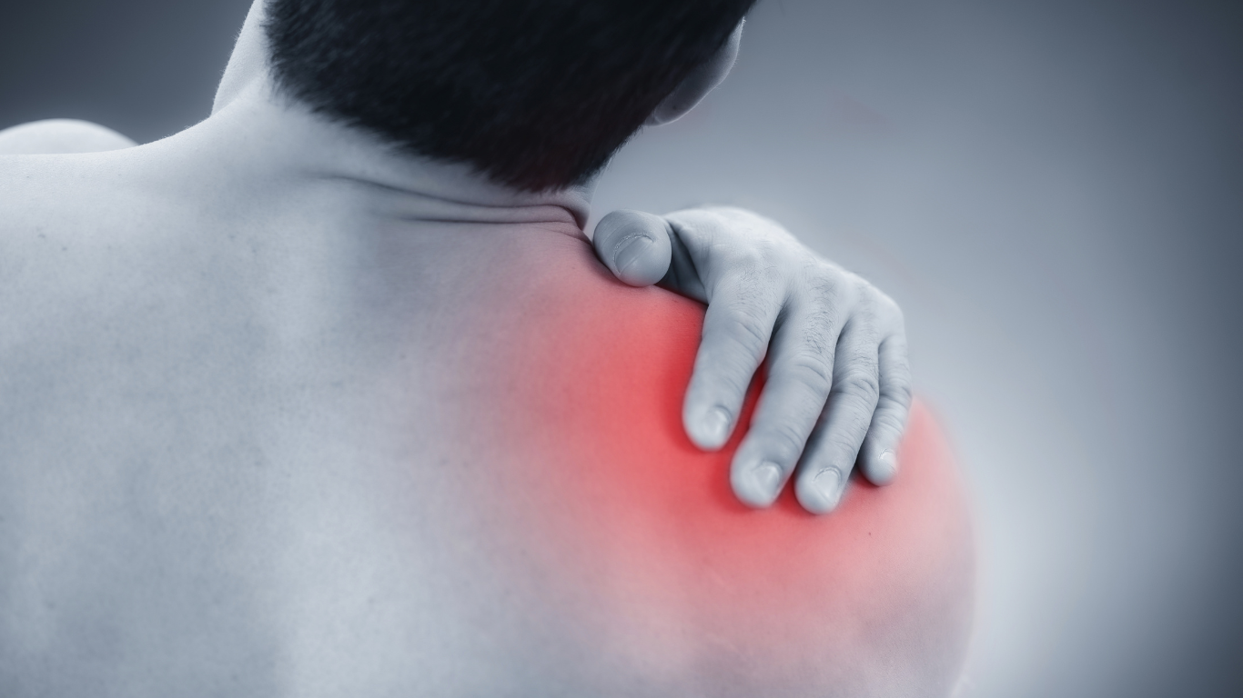 Person holding a painful red shoulder, indicating shoulder pain