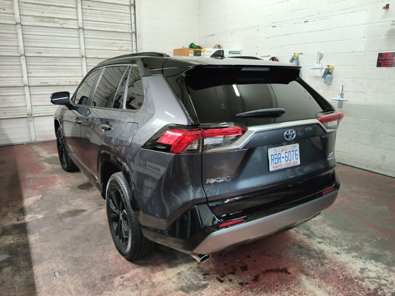 A toyota rav4 is parked in a garage.