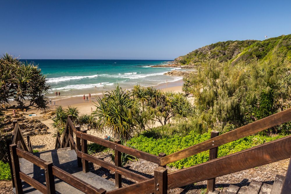 A Wooden Staircase Leading to a Beach With a View of the Ocean — Adzcom Civils in Port Douglas, QLD