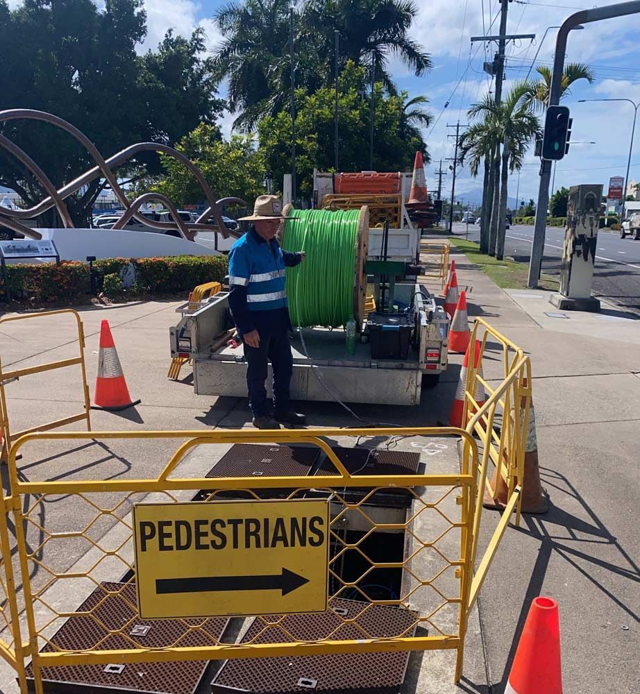 Worker Laying Down Fibre Optic Cable — Adzcom Civils in Portsmith, QLD