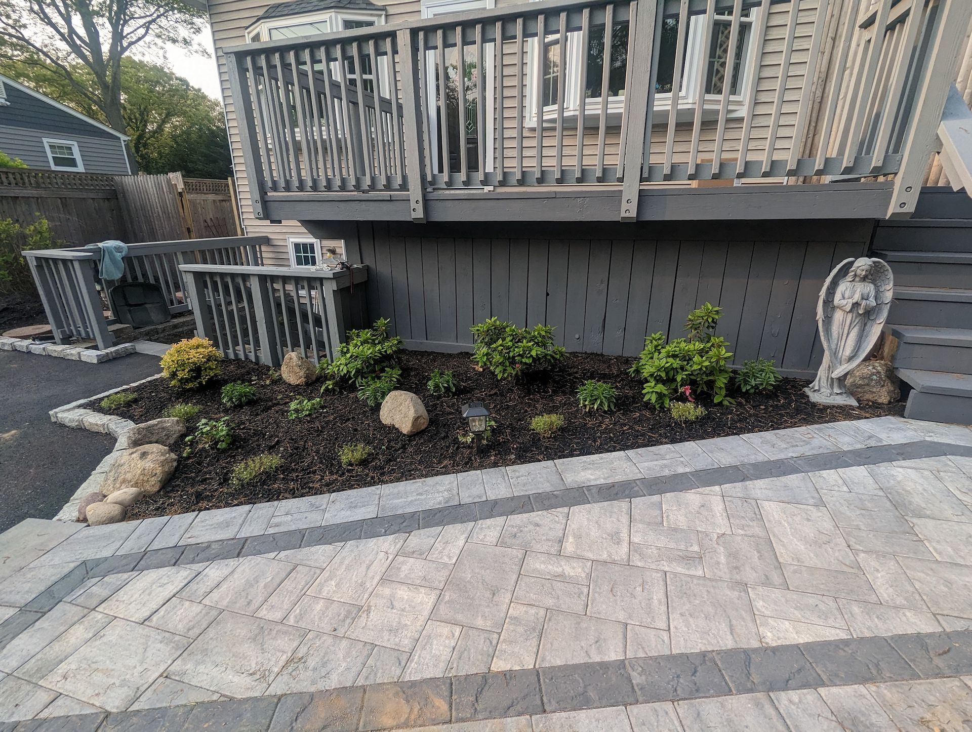 front yard landscaping with new plants, flowers and mulch