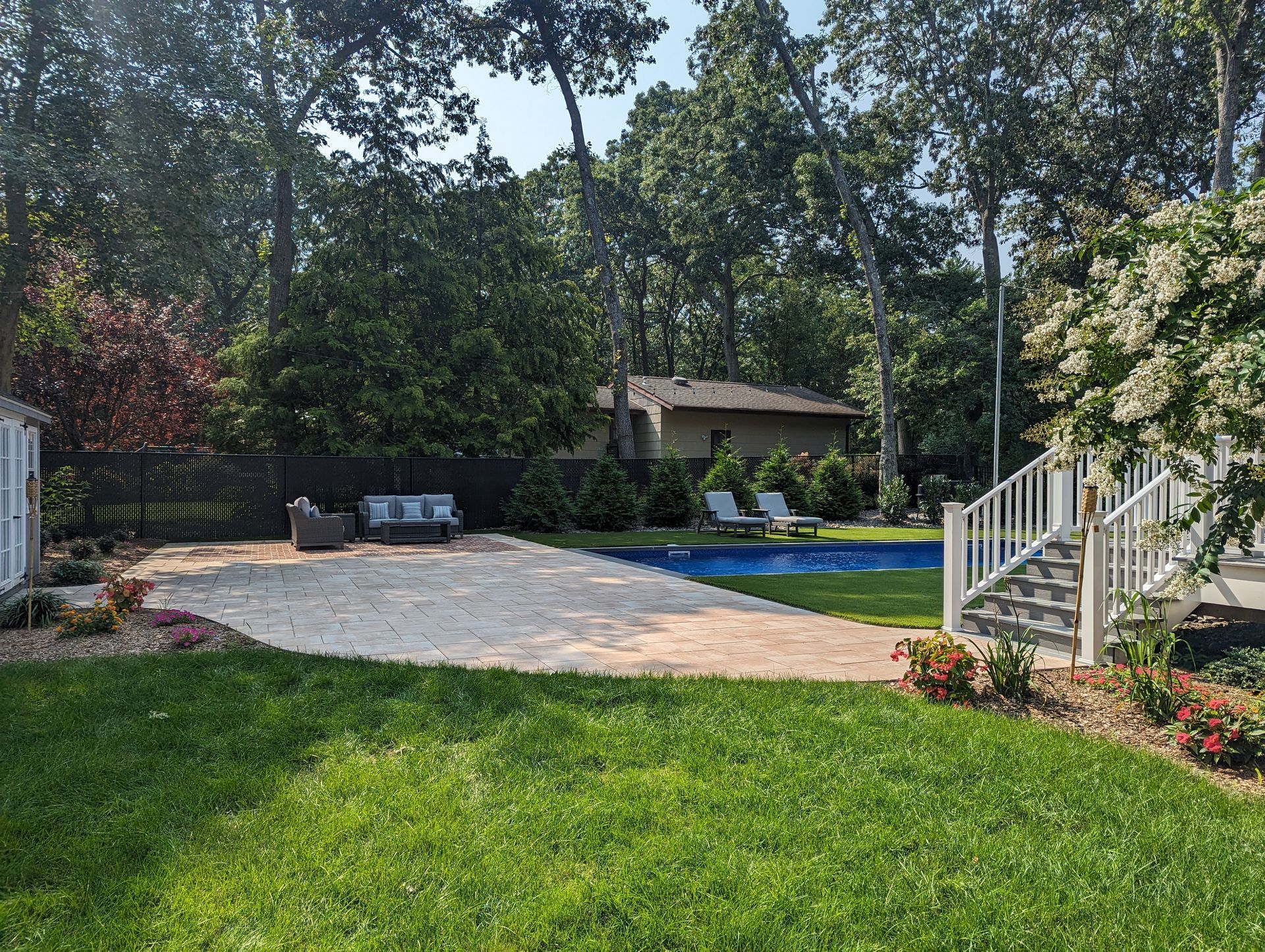 new sod around tile pavers in backyard area