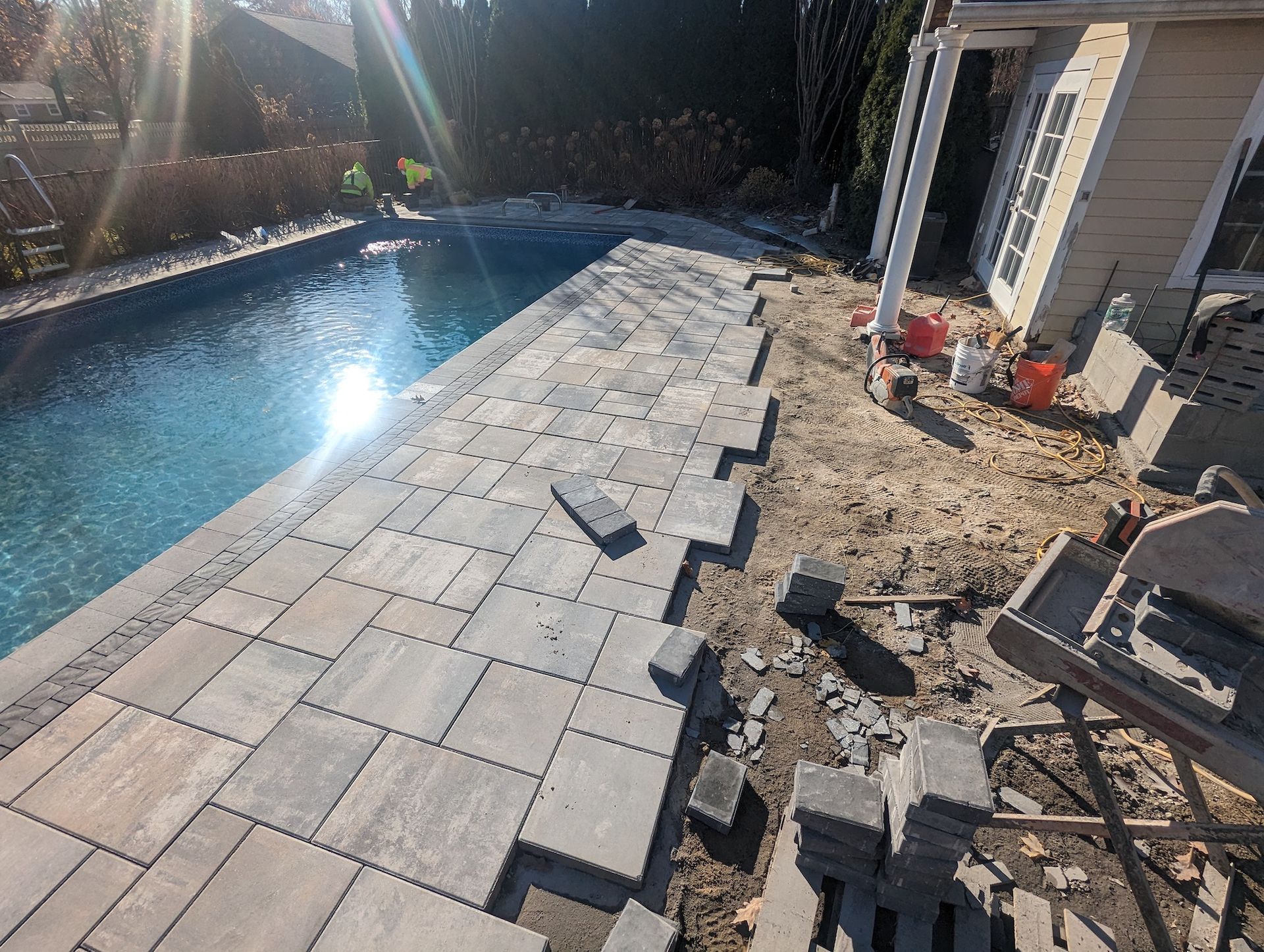 installation in progress of new tile around pool