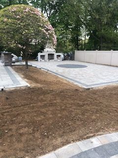 new backyard paver patio and fireplace area