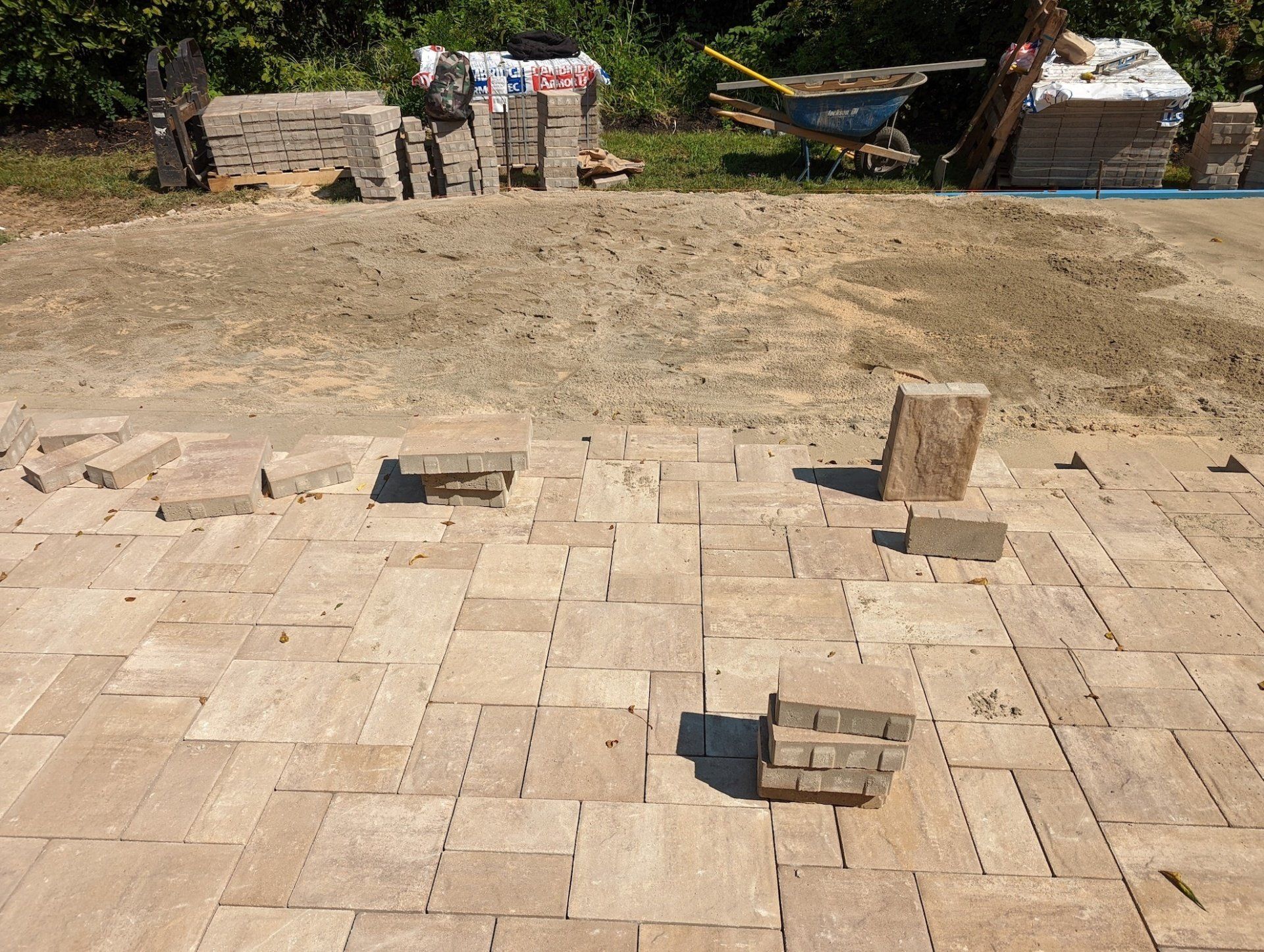 A pile of bricks sitting on top of a dirt field