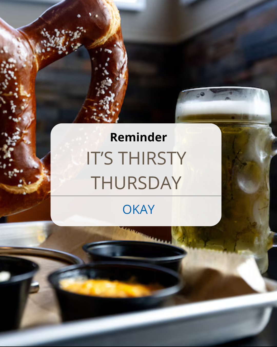 Beer mug and pretzel on a table with a “Thirsty Thursday” reminder popup.