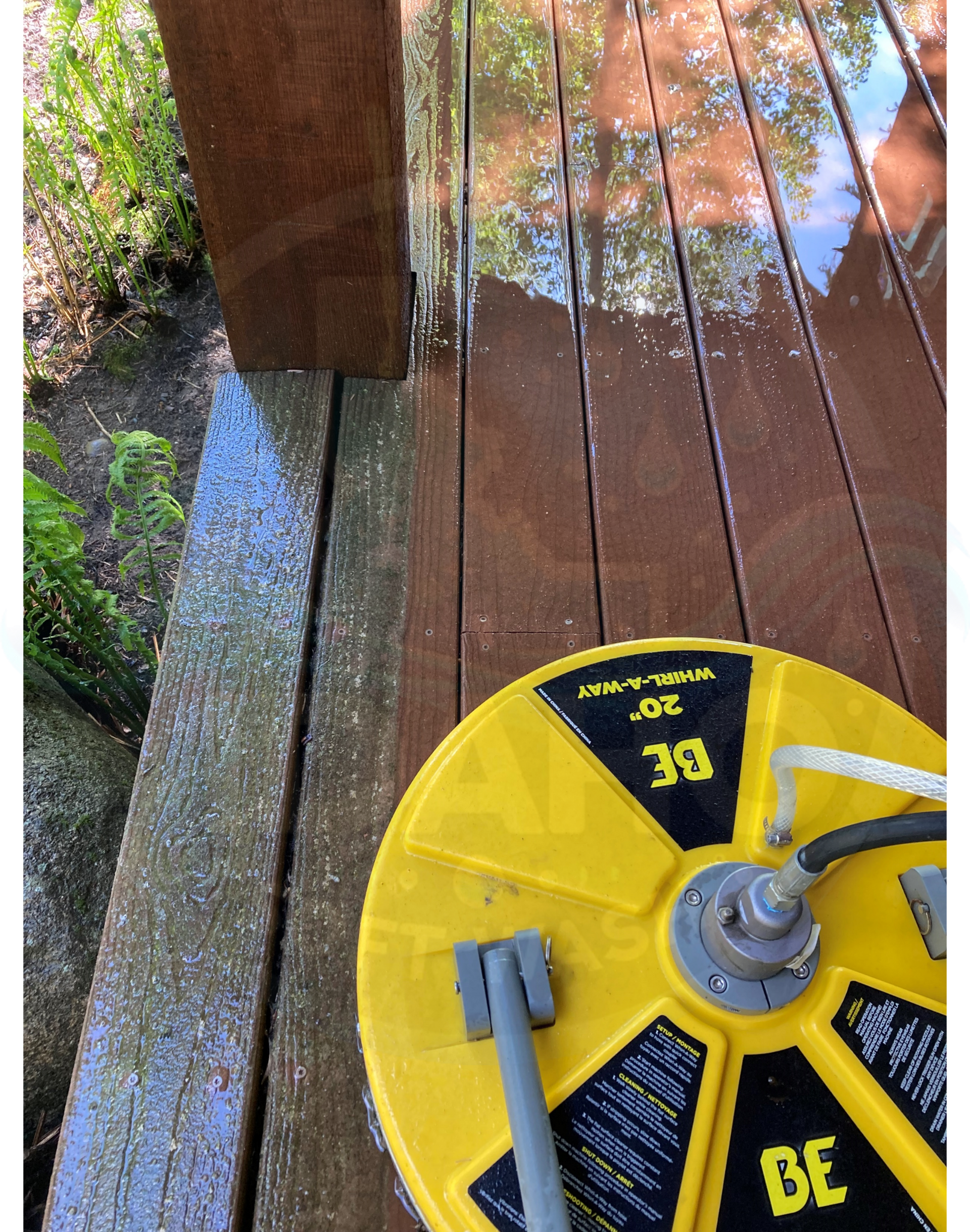 A yellow and black device is sitting on a wooden deck.