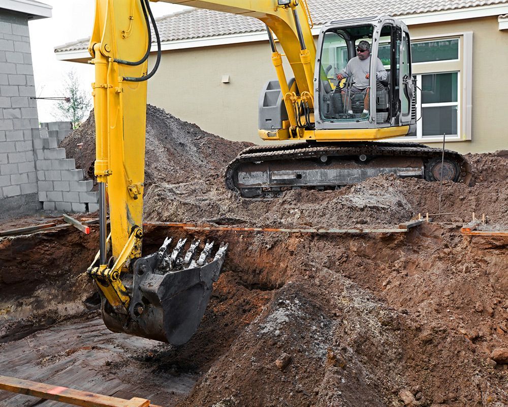 A contractor from Graber Demolition is performing inground pool removal by excavating the land in Ve