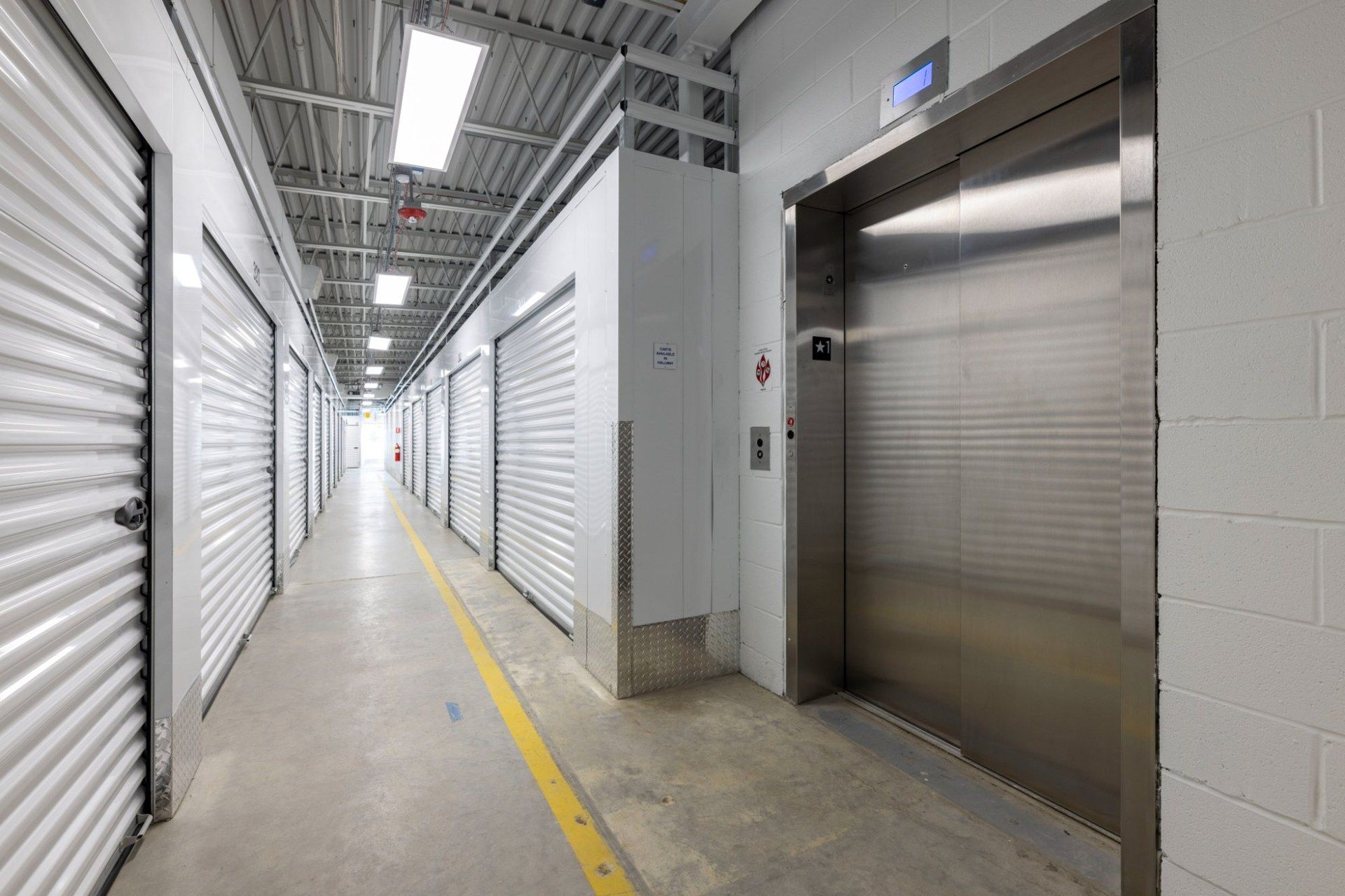Indoor storage unit hallway with elevator at Storage Place in Cranston, RI