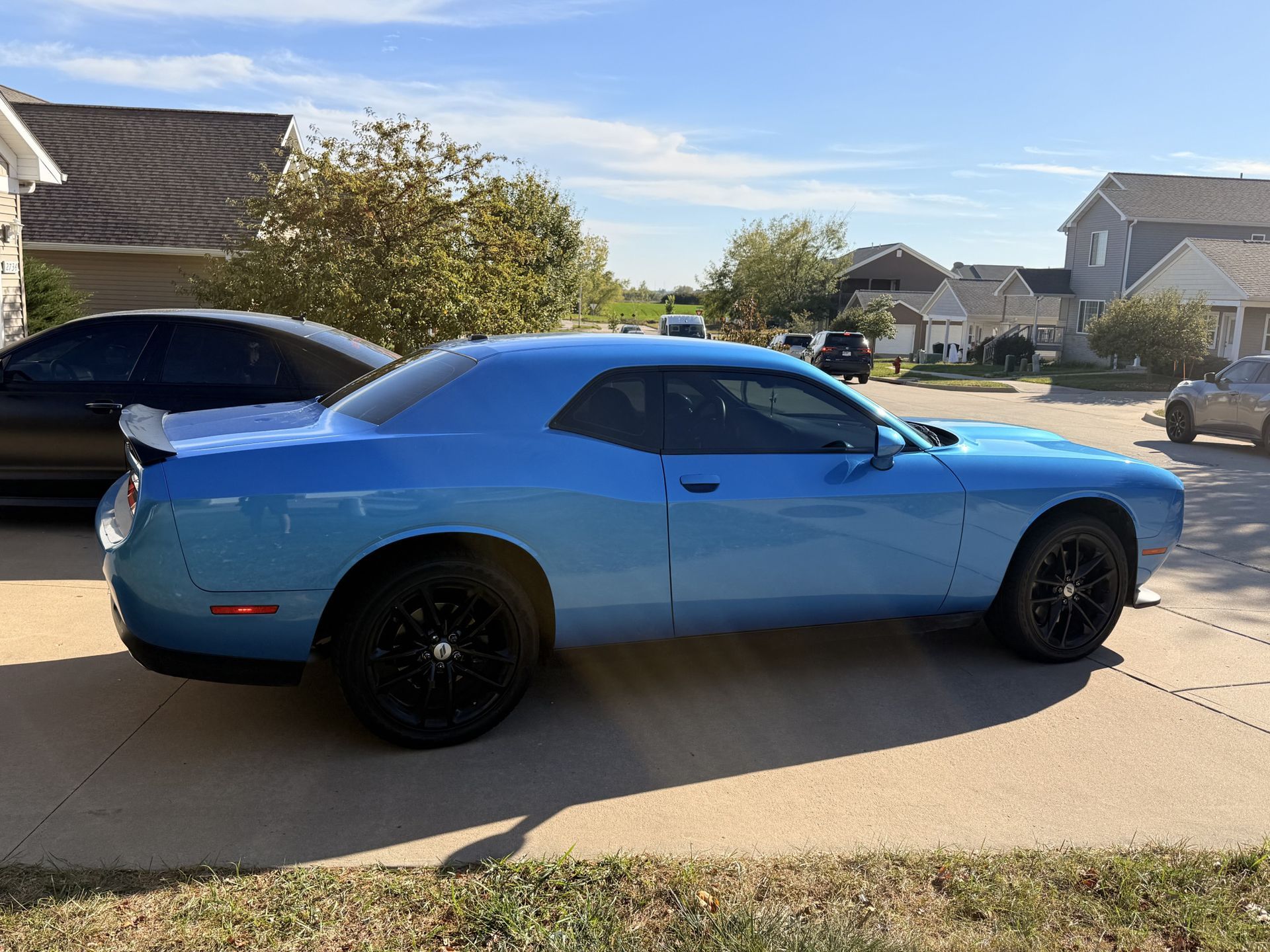 Blue Dodge Challenger muscle car with ceramic window tint installation