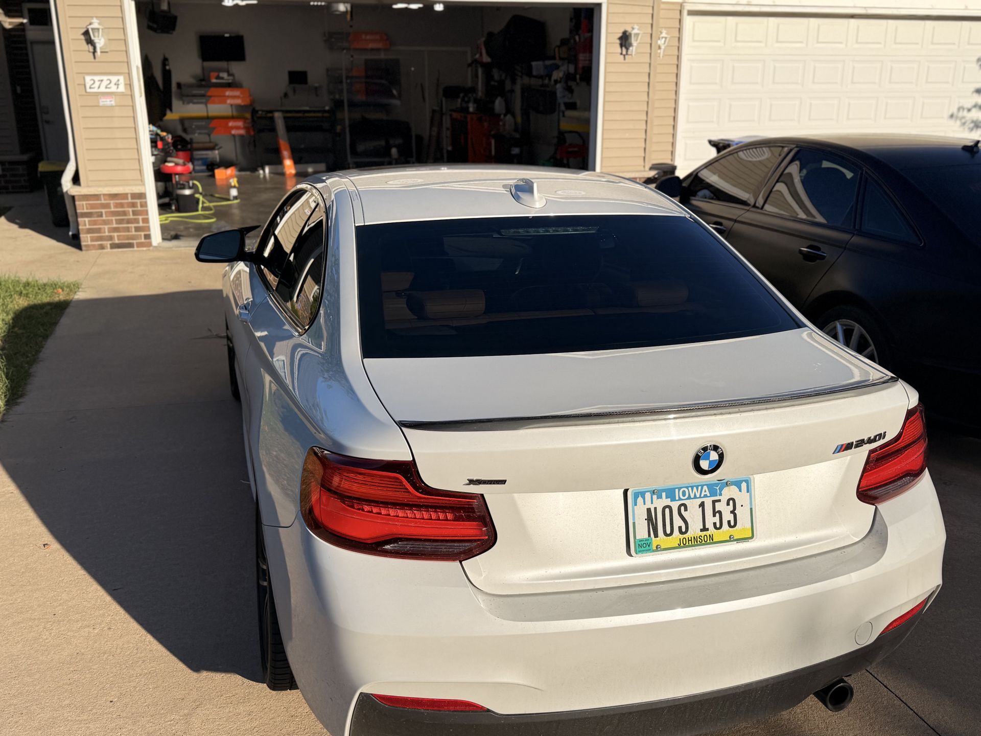 Blue Dodge Challenger with full window tint installation in driveway