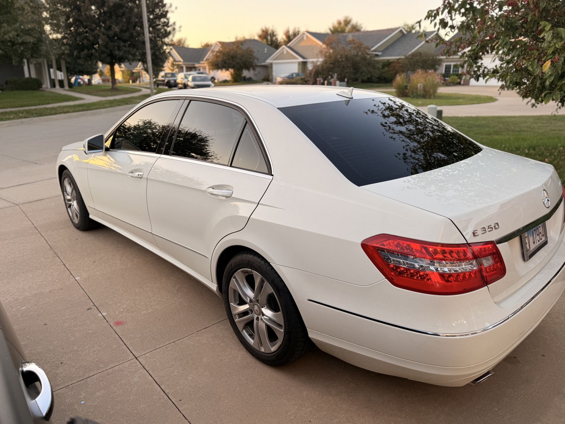 Black BMW sedan in residential garage with dark window tint