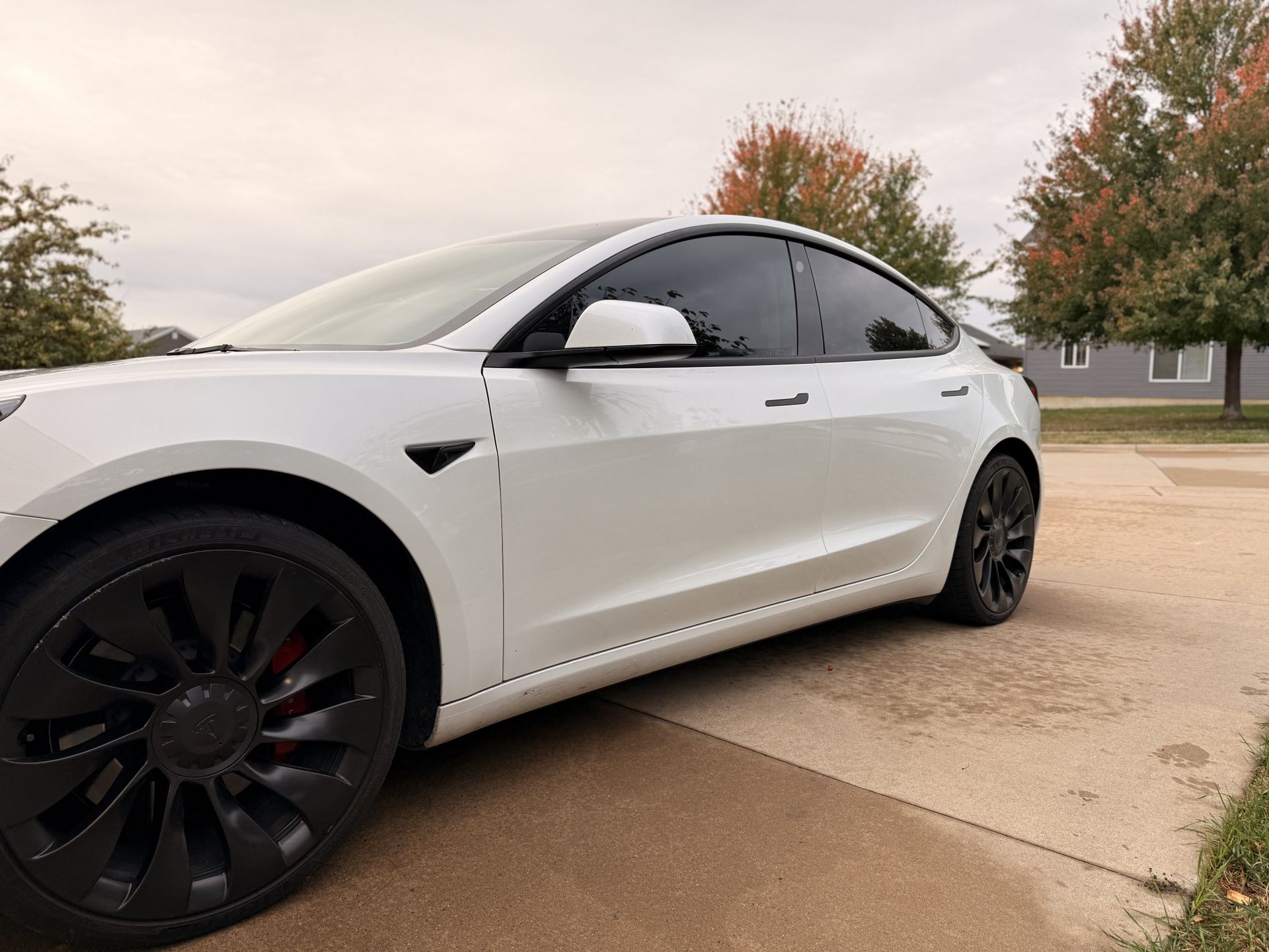 White Tesla Model 3 with ceramic window tint installed by Next Tier Tinting