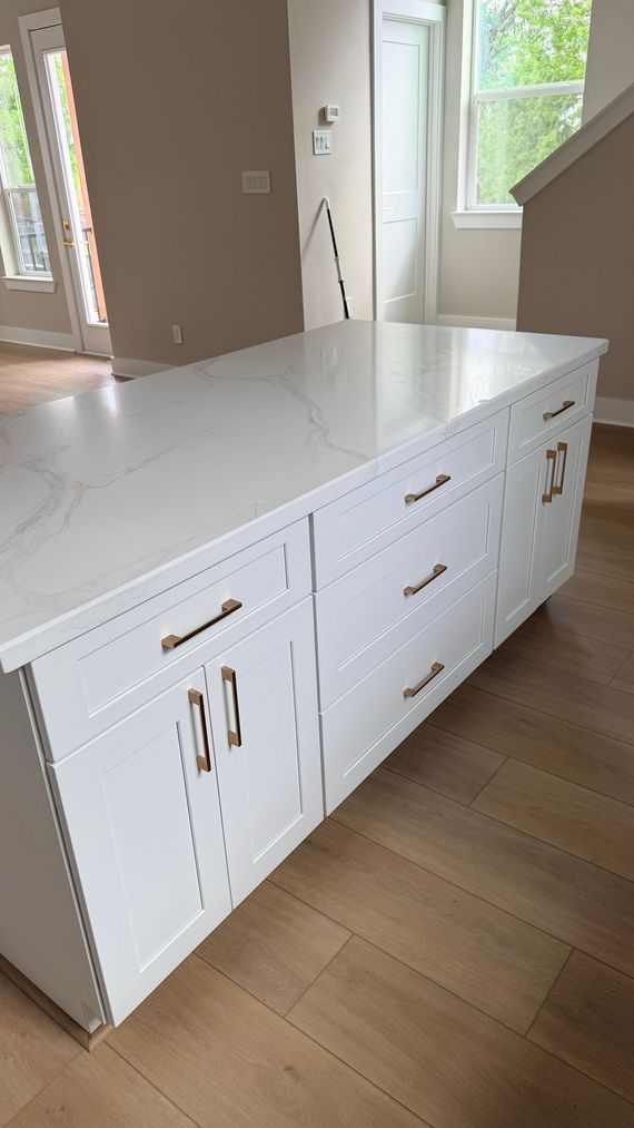 Kitchen cabinets before and after. Brown cabinets transformed to gray, with a stainless steel range.