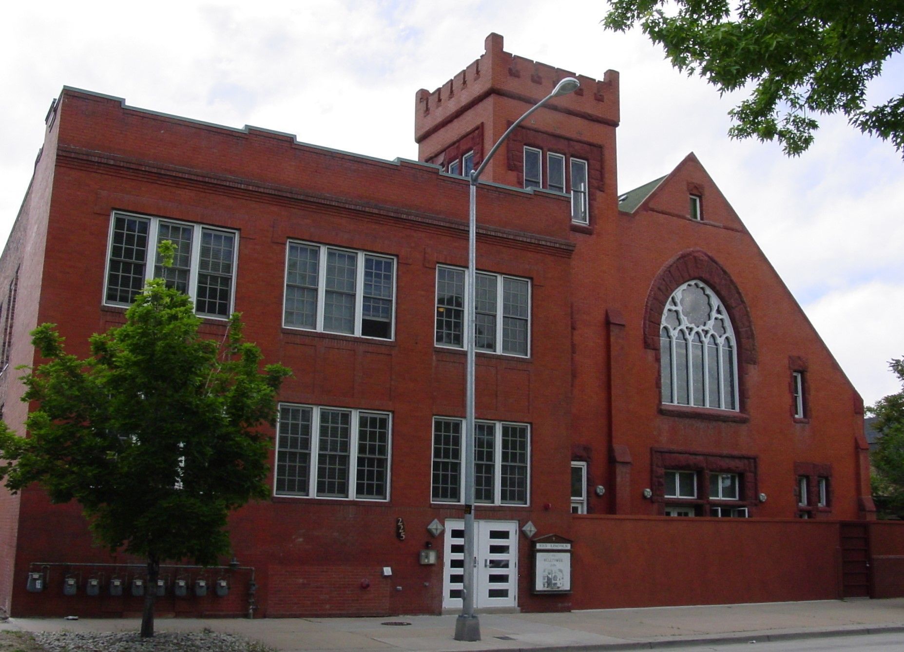 A large red brick building with a tower on top