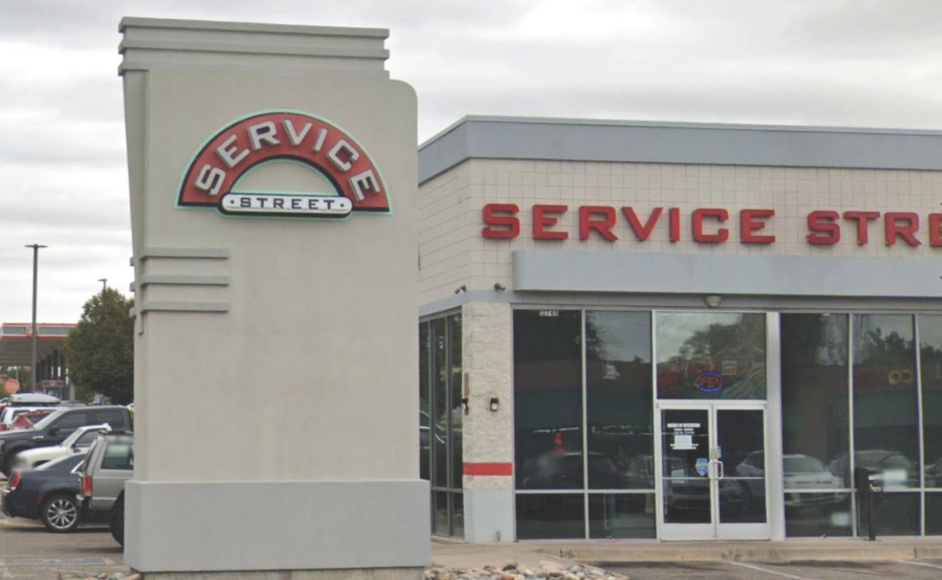 A service store with cars parked in front of it