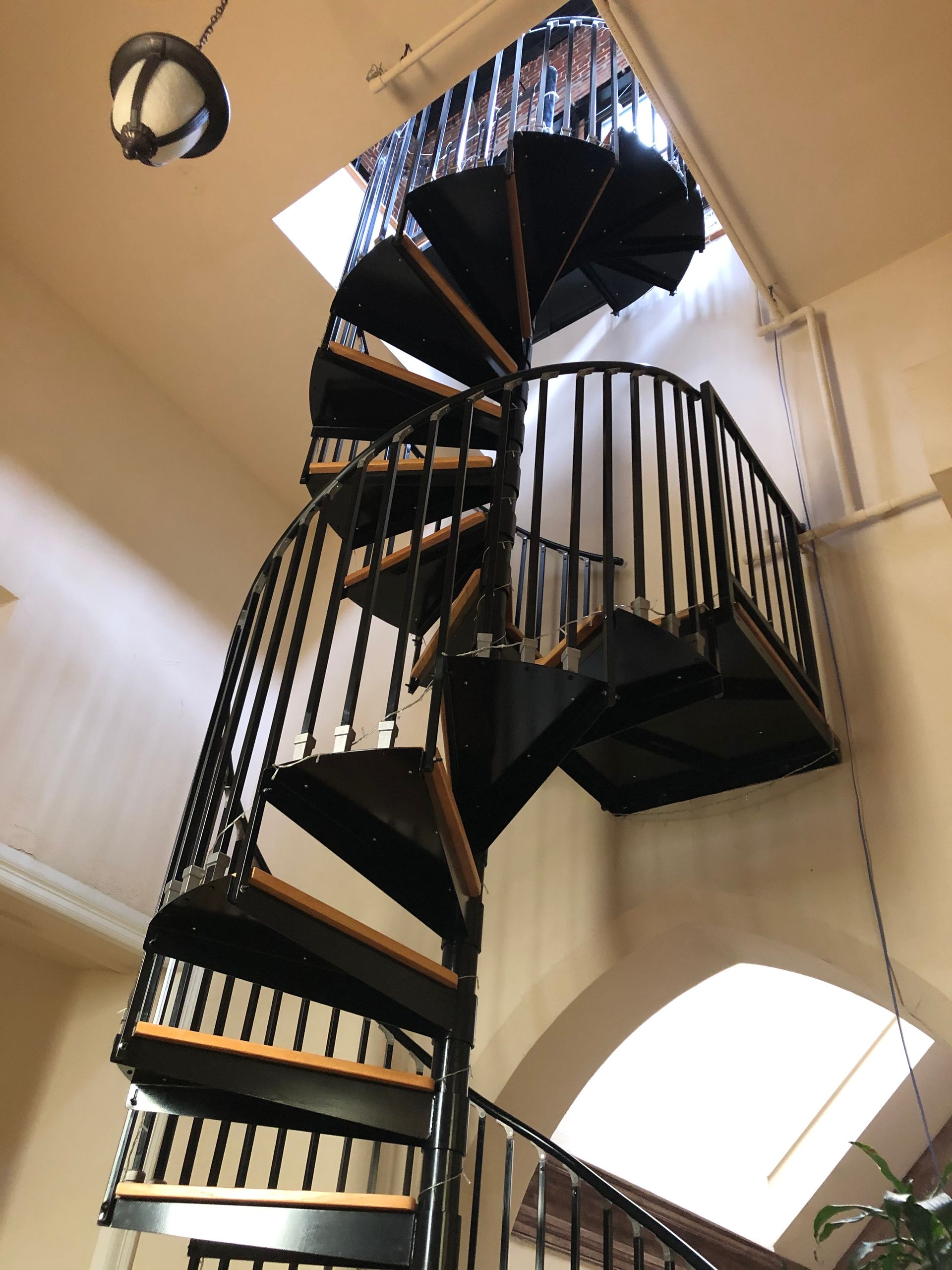A spiral staircase going up to the top of a building