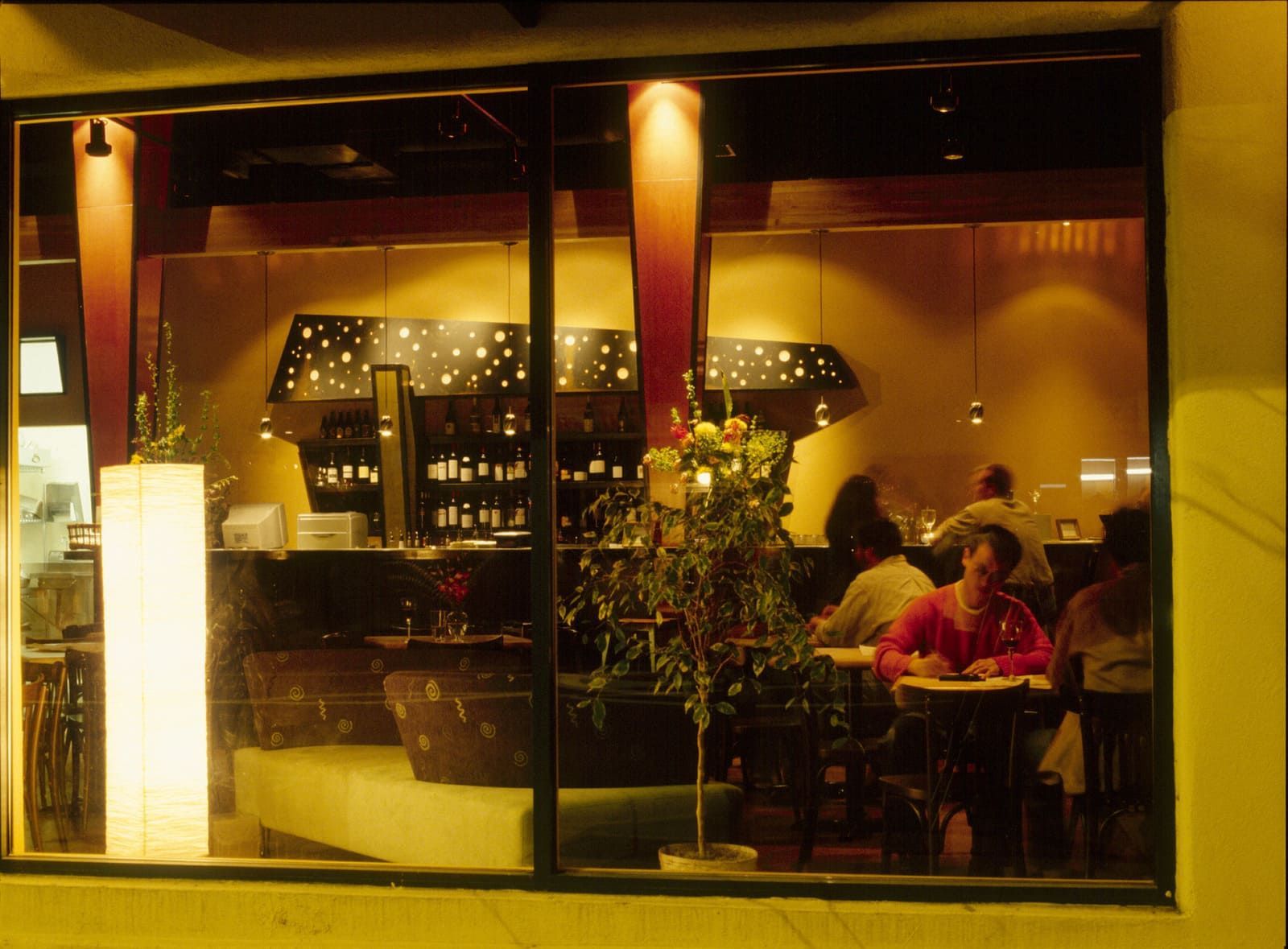 A group of people are sitting at tables in a restaurant